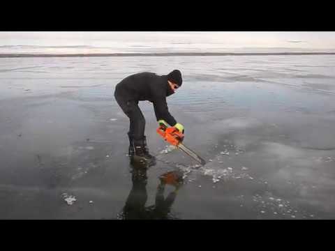 cutting a hole in lake ice with chainsaw-tobin lake