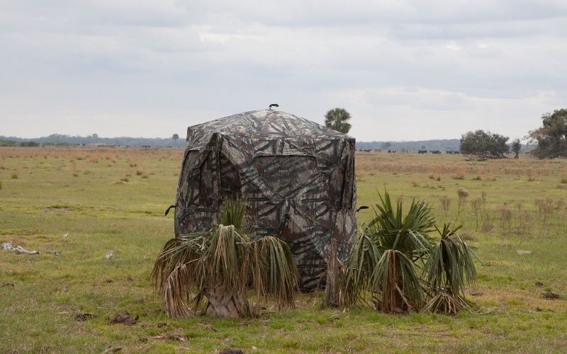 a hunting blind on a green field