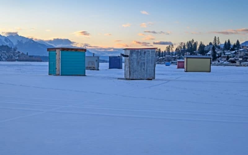 a lot of ice fishing shelters