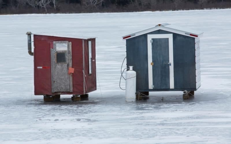two ice fishing shelters